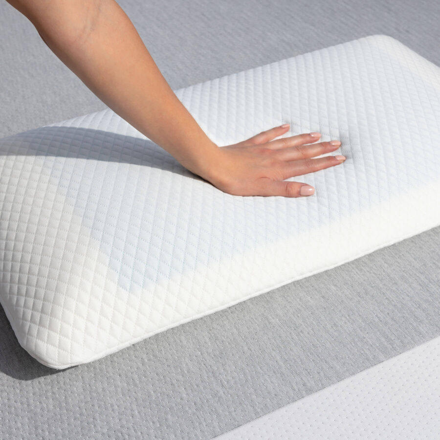 Hand pressing in to the surface of a Juno Cooling Gel Pillow