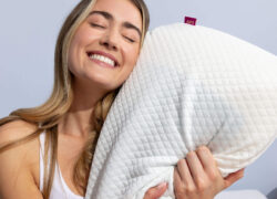 Woman smiling and hugging her Juno Cooling Gel Pillow