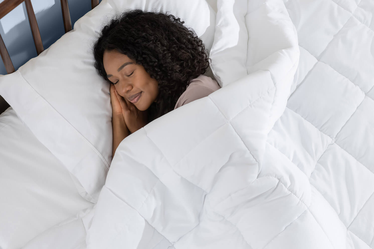 Woman sleeping peacefully with a Juno Down Alternative Duvet