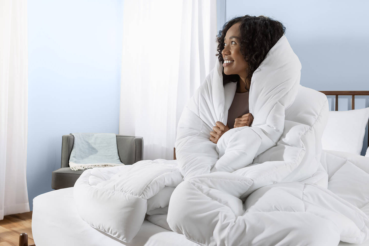 Woman with her Juno Down Alternative Duvet wrapped around her body