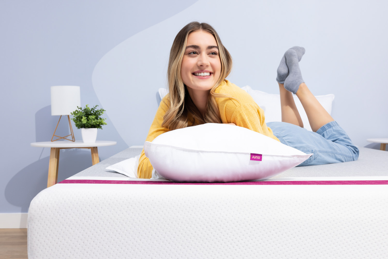 Woman lying with her Juno Down Alternative Pillow
