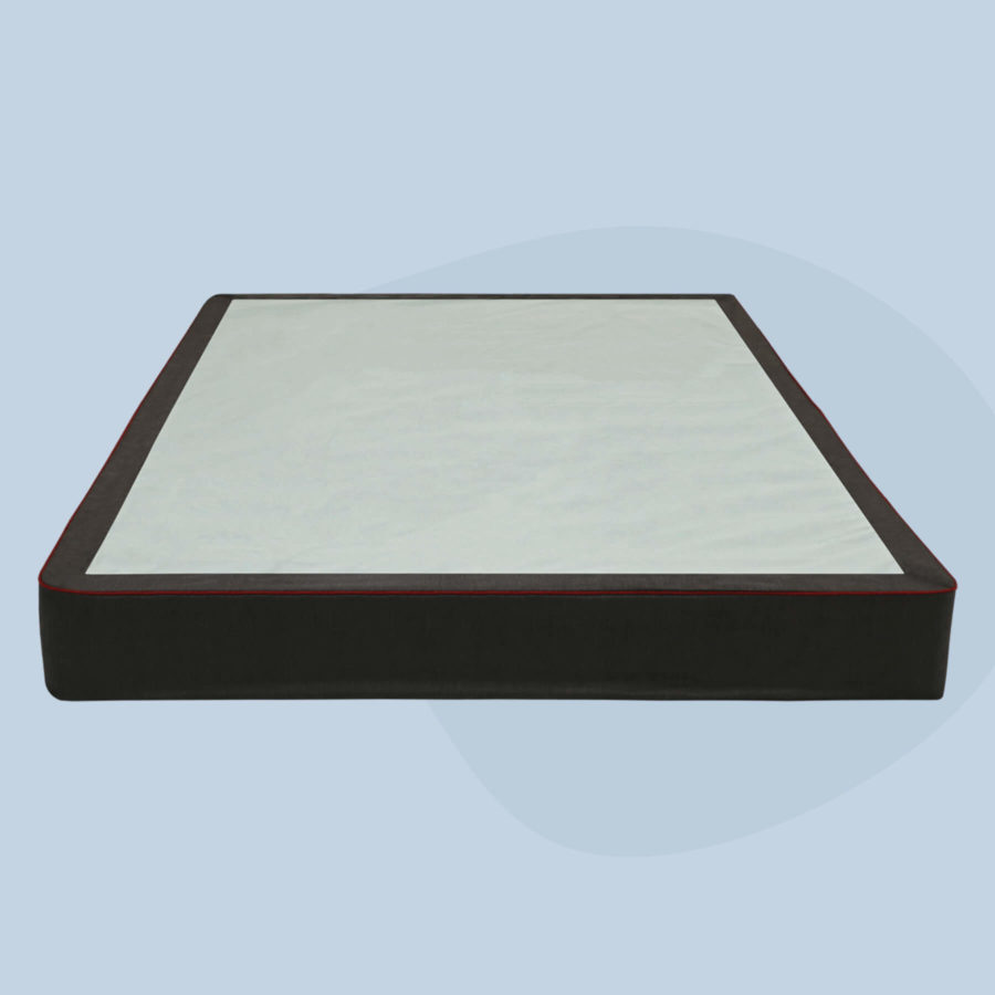 A Juno Foundation with a black sidewall cover and red stitching sits against a light blue background.