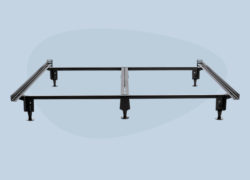 A Juno metal bed frame sits assembled against a light blue background.