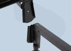 A close up of the Juno metal bed frame rails sliding on to the legs.