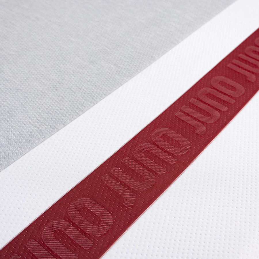Close up of the red stripe on the foot of the Juno Mattress cover.