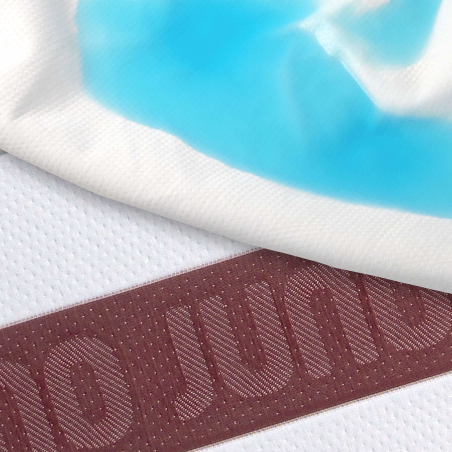 Blue liquid is absorbed by the Juno mattress protector and shows the clean, protected Juno mattress beneath.