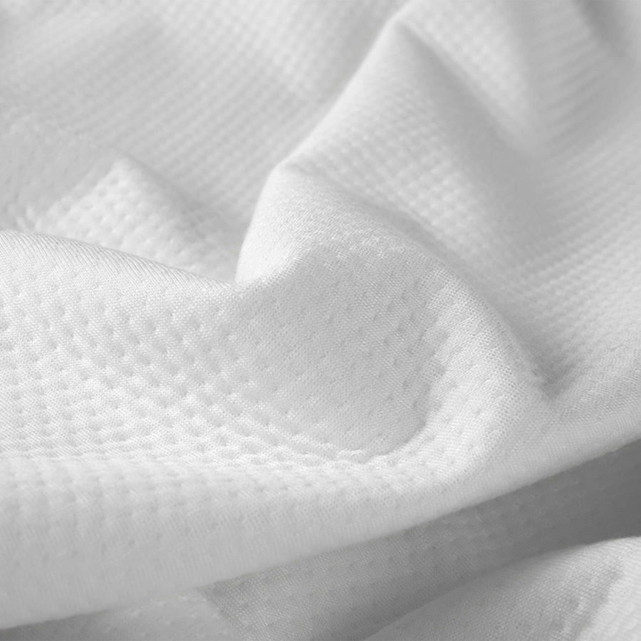 A close up view that shows the dimpled pattern on the Juno mattress protector.