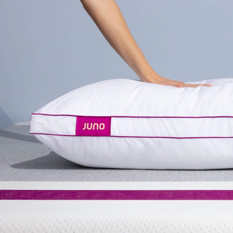 Hand pressing into a Juno Adjustable Memory Foam Pillow