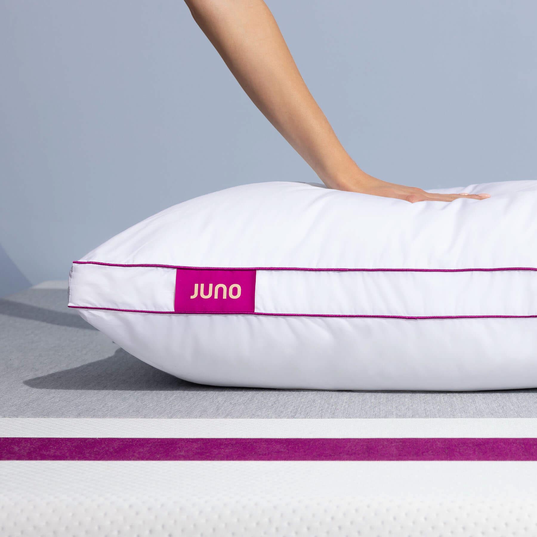 JB-MemoryFoamPillow-2023-Carousel-7 Hand pressing into a Juno Adjustable Memory Foam Pillow