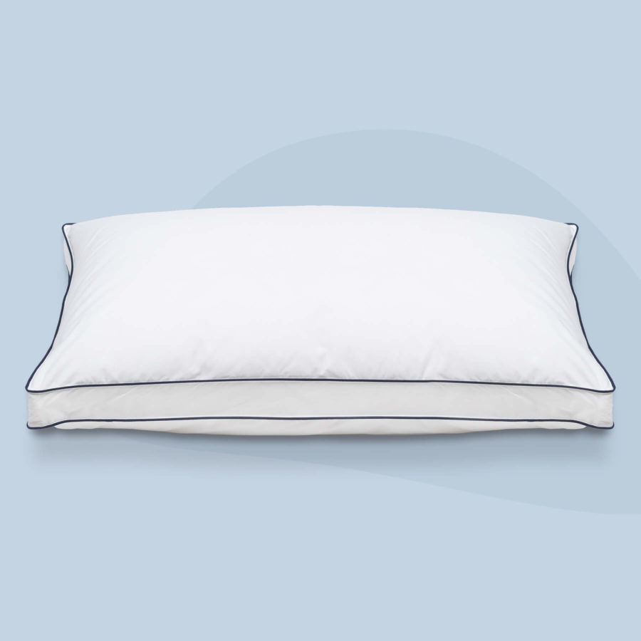 A Juno adjustable memory foam pillow sits plush against a light blue background.