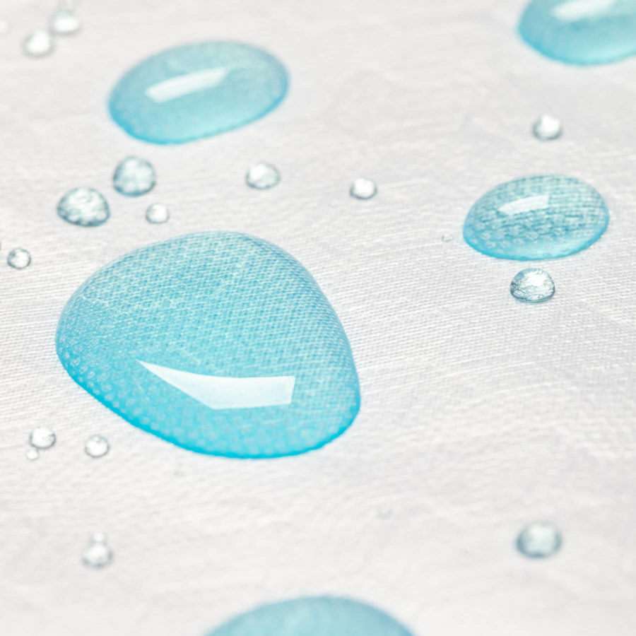 A close up of blue water droplets beading as they rest on the Juno pillow protector.