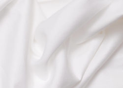 A close up view of the Juno sheet set, showcasing it's unique sateen weave.