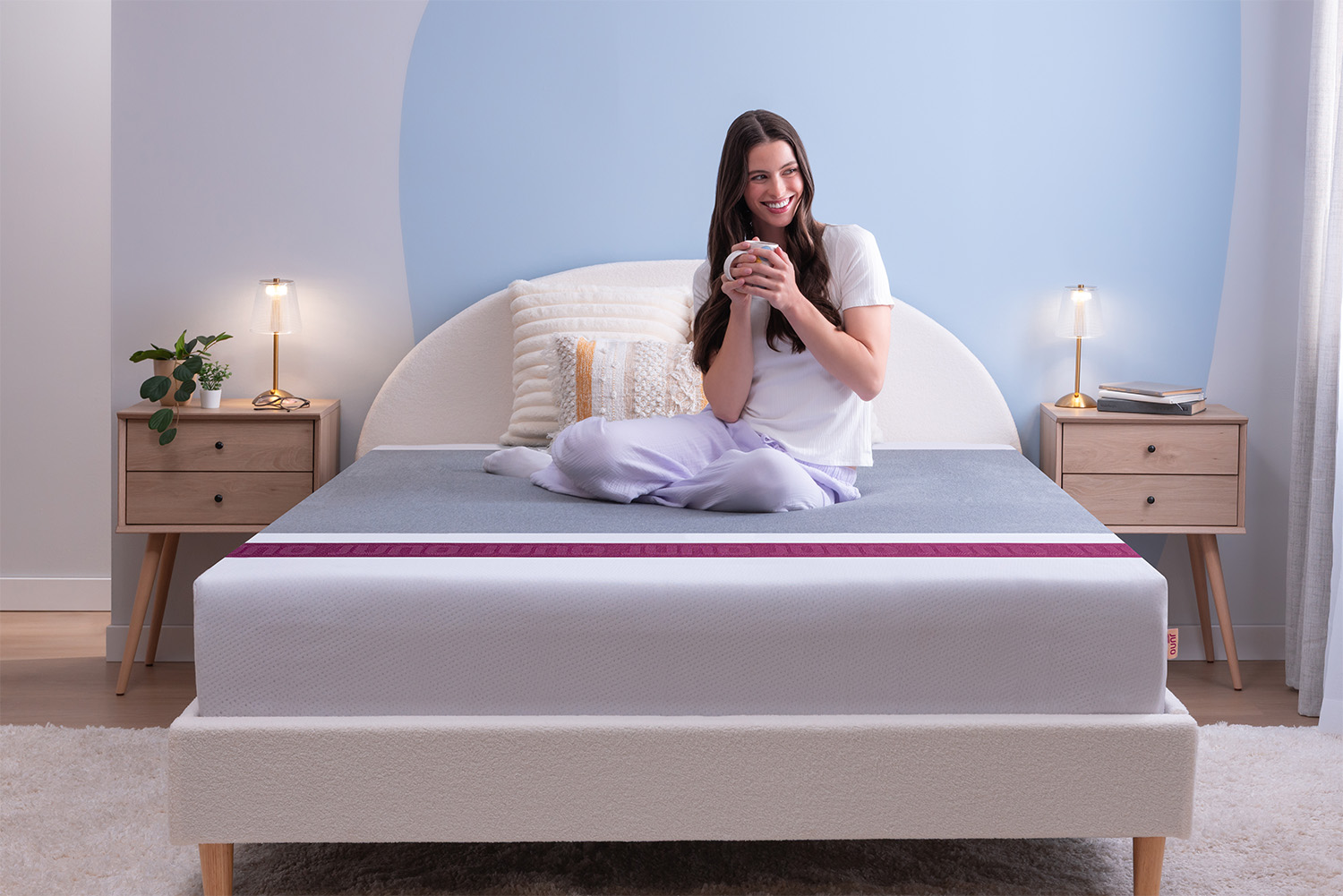 A woman sleeping peacefully on a Juno Hybrid mattress.