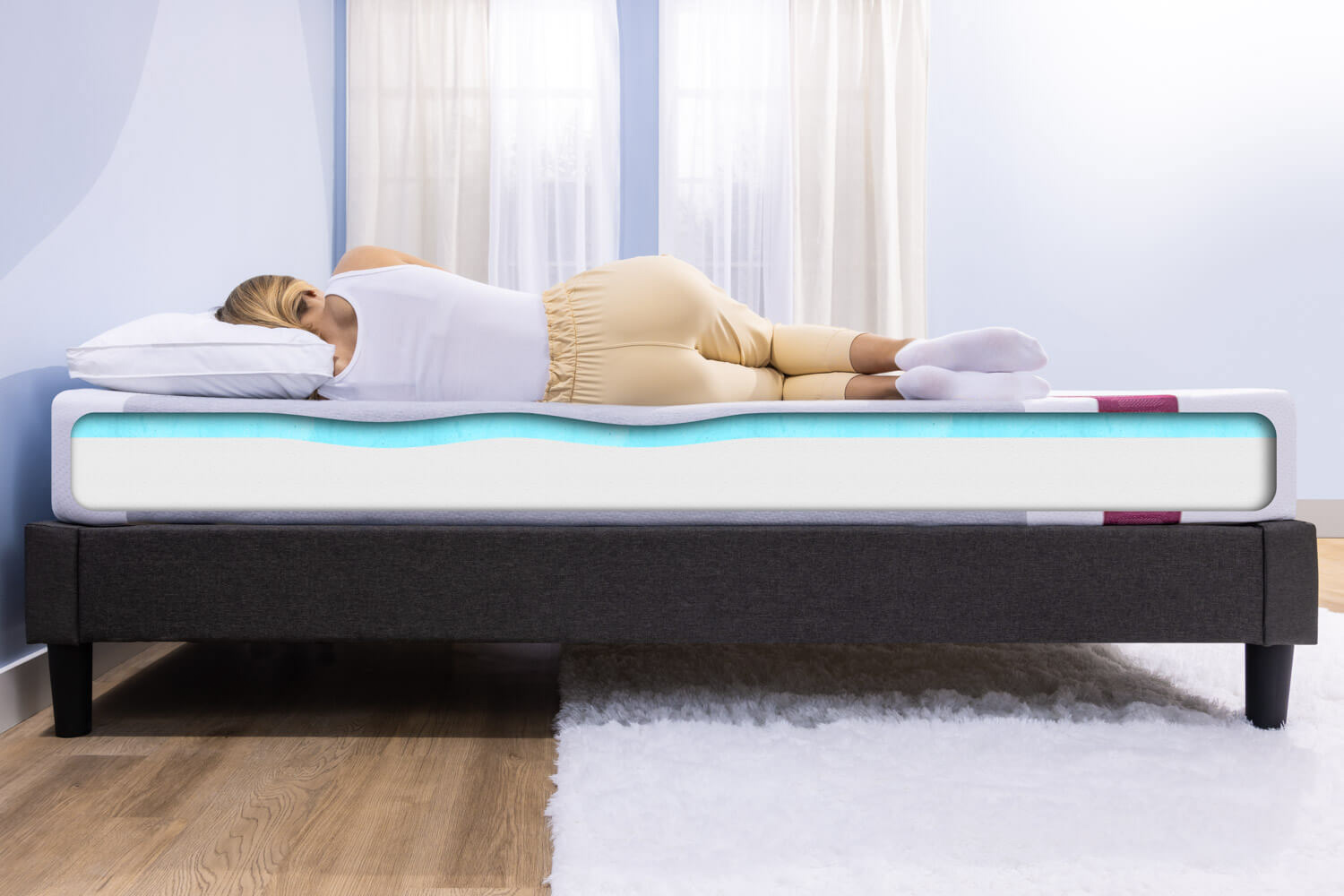Woman sleeping on her side on a Juno mattress with the two foam layers showing