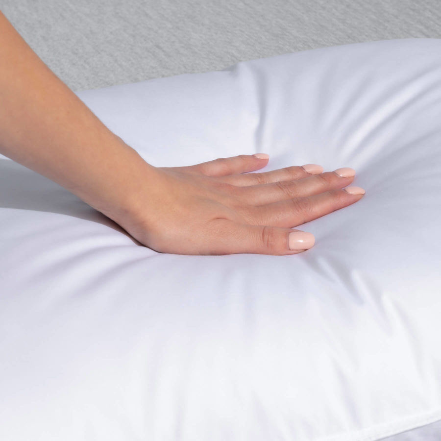 Hand pressing into a Juno Down Alternative Pillow
